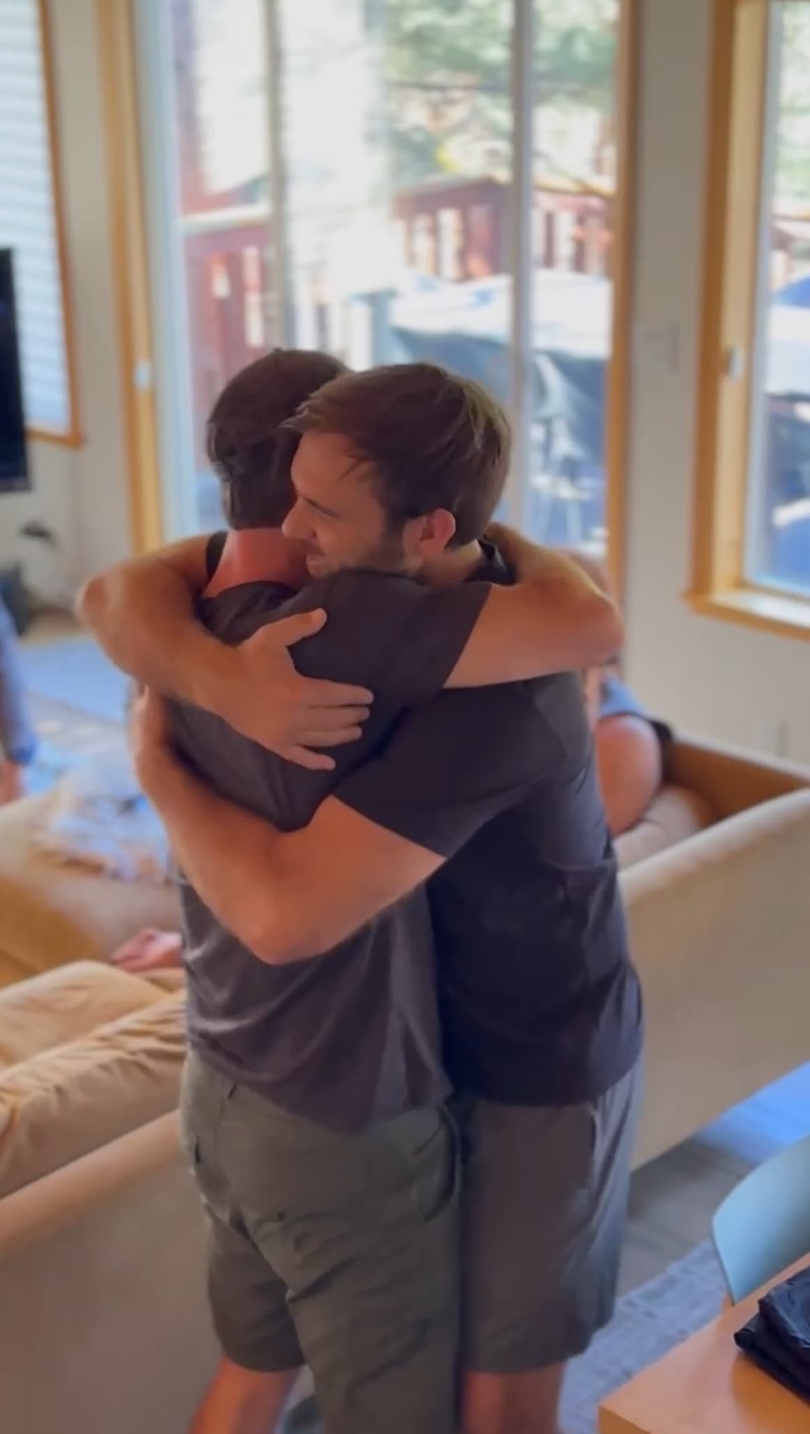 A group of three individuals posing for a photo on a hiking trail