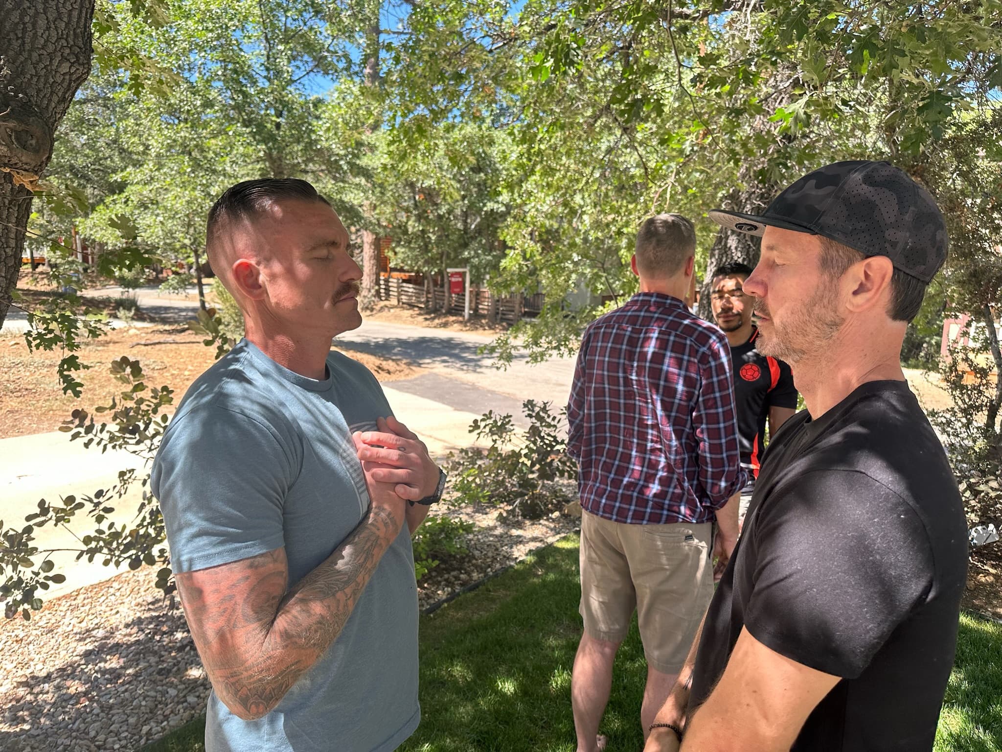 Two participants in a group healing session outdoors