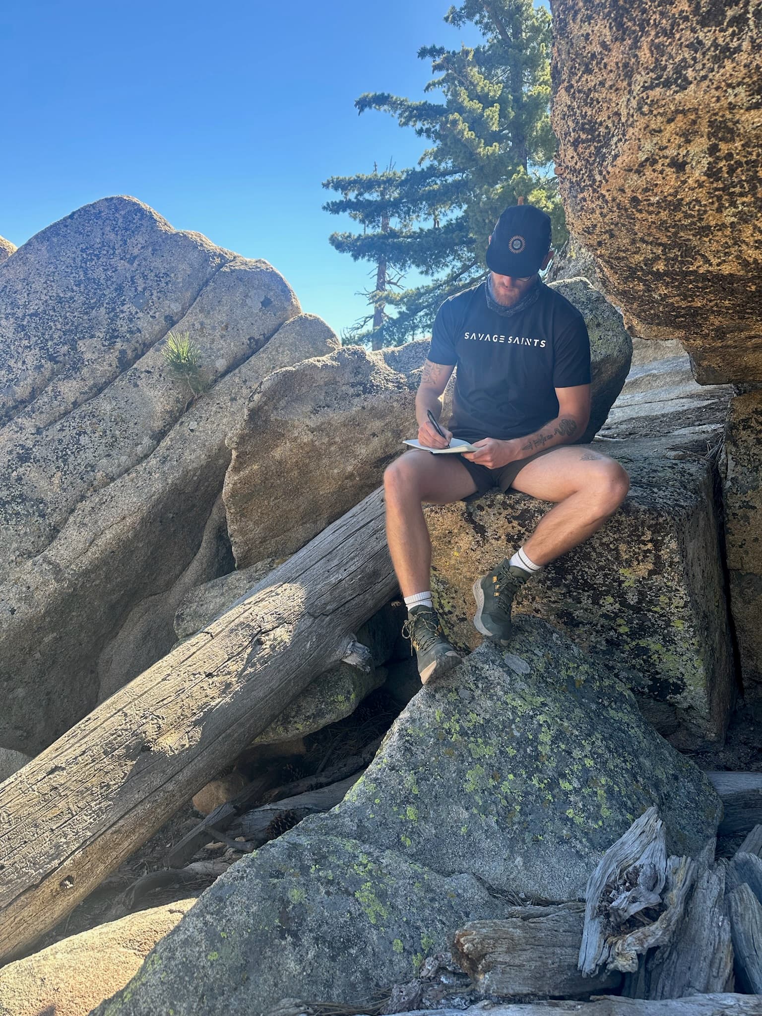 Members engaged in reflective writing outdoors